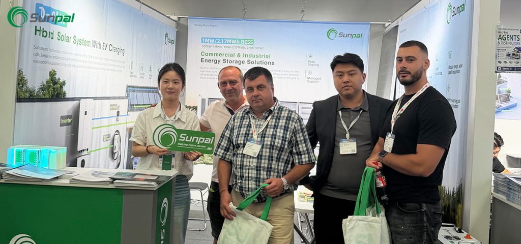 A group of five professionals posing together inside the Sunpal exhibition booth at The Smarter E Europe 2026, surrounded by banners showcasing commercial and industrial solar energy storage solutions.