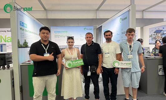 Sunpal team posing at an exhibition booth during a trade show.